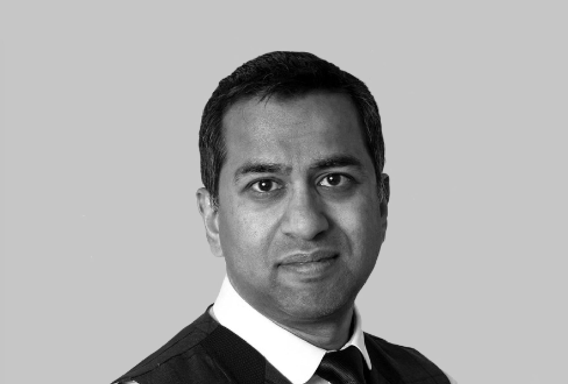 Black and white photo of Dowshan Humzah, independent board director and transformation specialist